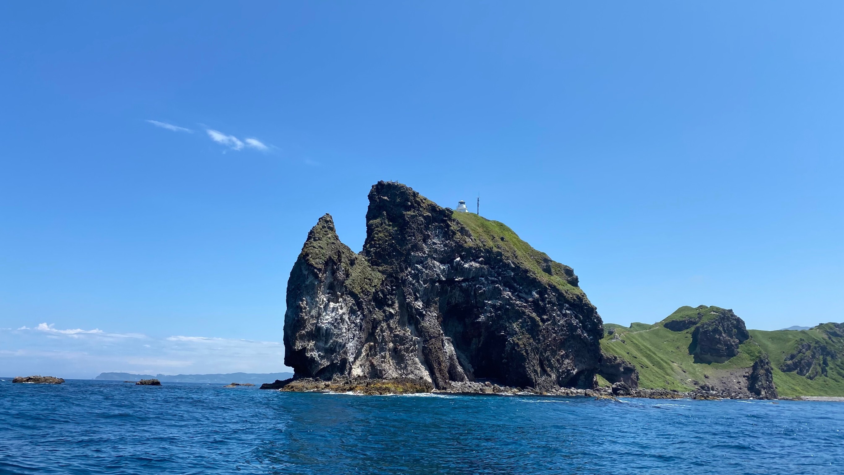 Viewing the cliffs of Cape Kamui from a boat
